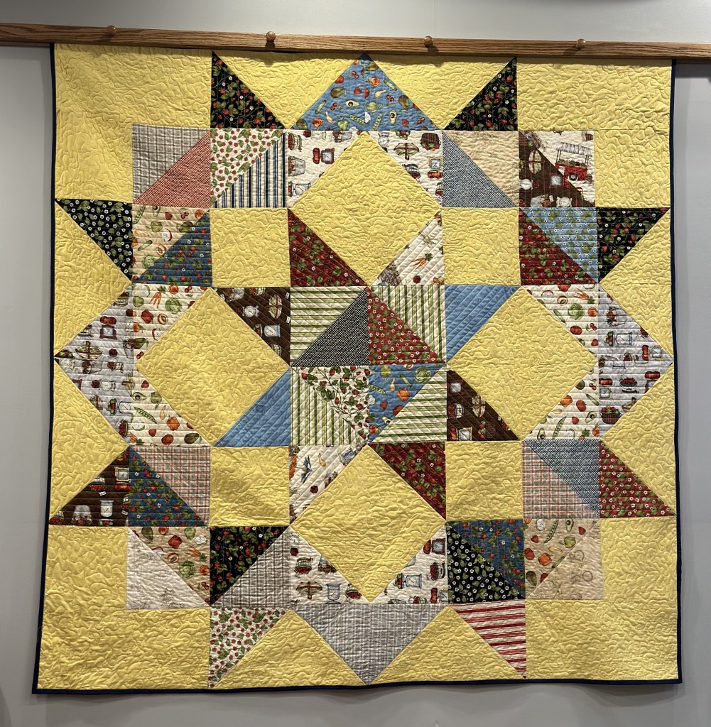 big star quilt with yellow background and fruit and vegetable prints